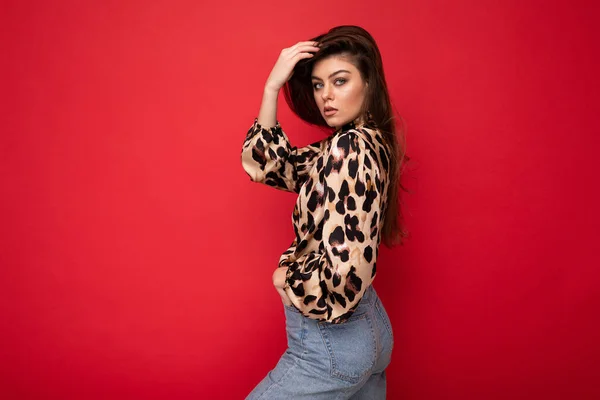 Close-up portrait of young nice-looking attractive lovely glamorous brunet woman wearing leopard blouse isolated on red color background with free space — Stock Photo, Image