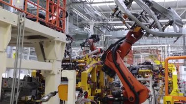 Kaynak yapmadan önce bir detayı olan bir araba fabrikasında robot, otomasyon.