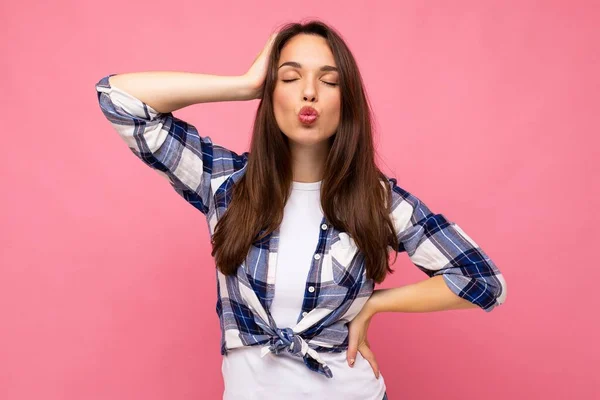 Photo of young positive happy beautiful woman with sincere emotions wearing stylish clothes isolated over background with copy space and giving kiss — Stock Photo, Image