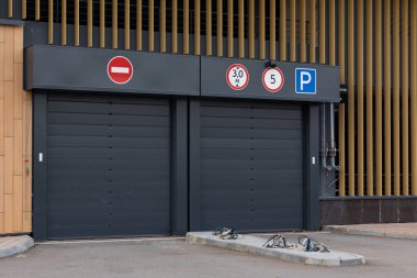 Yeraltı otoparkına girmek için siyah kapı.
