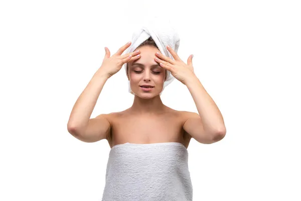 Beautiful woman with well-groomed smooth skin massages her forehead after a shower makes a cosmetic massage — Stock Photo, Image