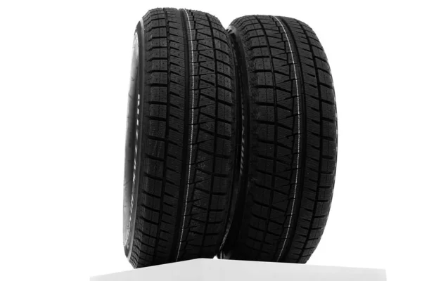 Winter tires on a white wall background — Stock Photo, Image