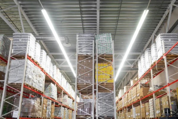 Panoramic photo of an automated warehouse logistics center with high-bay shelving, blurred photography, defocus — Stock Photo, Image