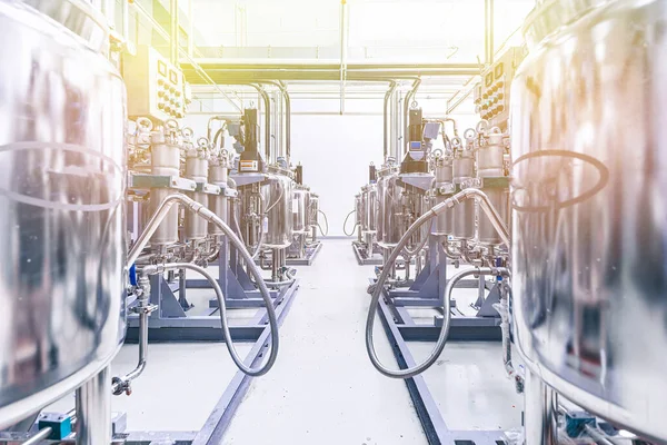 Photo of pipes and tanks. Chemistry and medicine production. Pharmaceutical factory. Interior of a high-tech plant, modern production. Yellow tone — Stockfoto