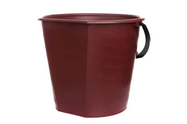 Empty brown plastic bucket with black handle on white isolated background — Zdjęcie stockowe