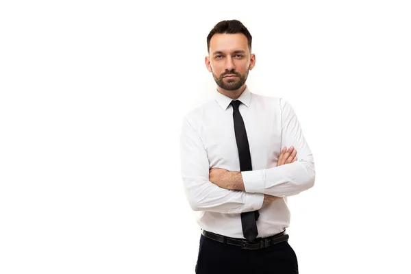 Serious man in a business shirt and a black tie with crossed arms on his chest on a white background, Concept of Management and and Human Resource Management in Business — Stock Photo, Image