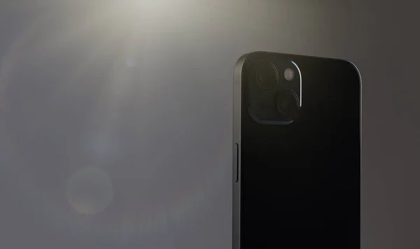 Zwart rechthoekige moderne smartphone met twee grote camera 's close-up op een grijze achtergrond met artistieke verlichting van bovenaf — Stockfoto