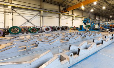 Metal levha profil oluşturma makinesi, çatı için çelik döşeme işlemi, endüstriyel üretim. Bitki ve fabrikanın arka planı