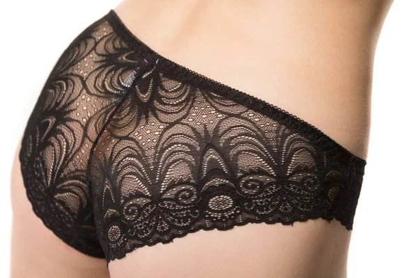 Girl in black lace panties, back view, half-length shot on a white background — Stock Photo, Image