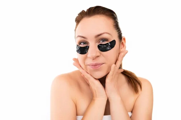 Young woman takes care of her skin on a white isolated background — Stock Photo, Image