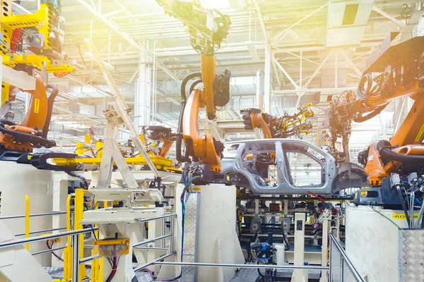 Photo of automobile production line. Welding car body. Modern car assembly plant. Auto industry. Yellow tone — Stock Photo, Image