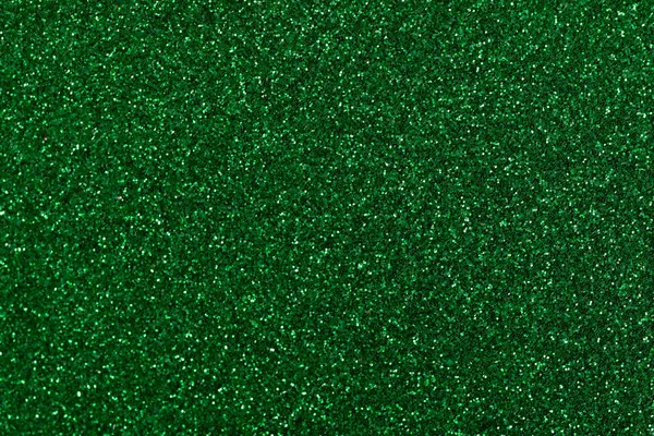 solid color emerald glitter background with depth of field, background with sparkles and glitters, colored sand paper textured background