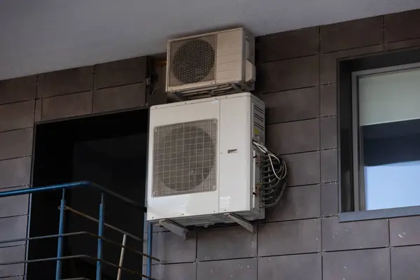block of climatic equipment of the air conditioner hanging outside the building.