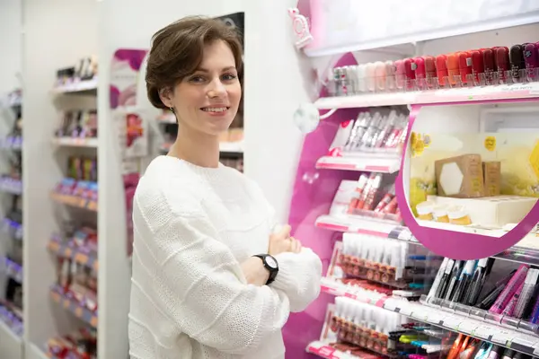 young woman buys cosmetics specialty store.