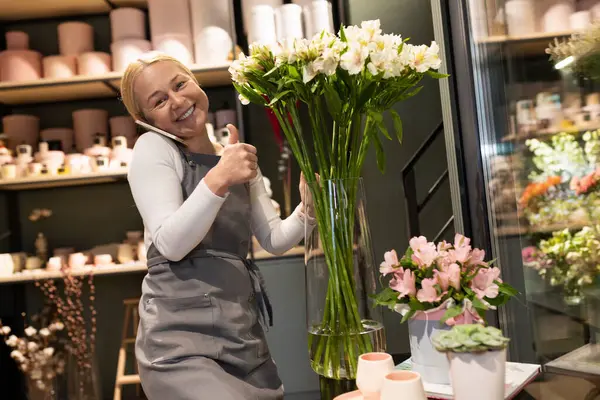 flower shop manager takes orders by phone.