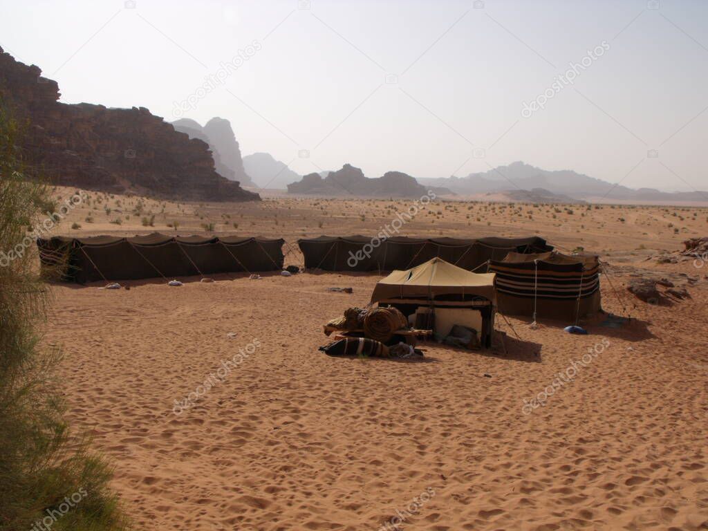 Wadi Rum desert, Jordan, August 14, 2010: Bedouin camp with tents planted in the sand in Wadi Rum desert, Jordan