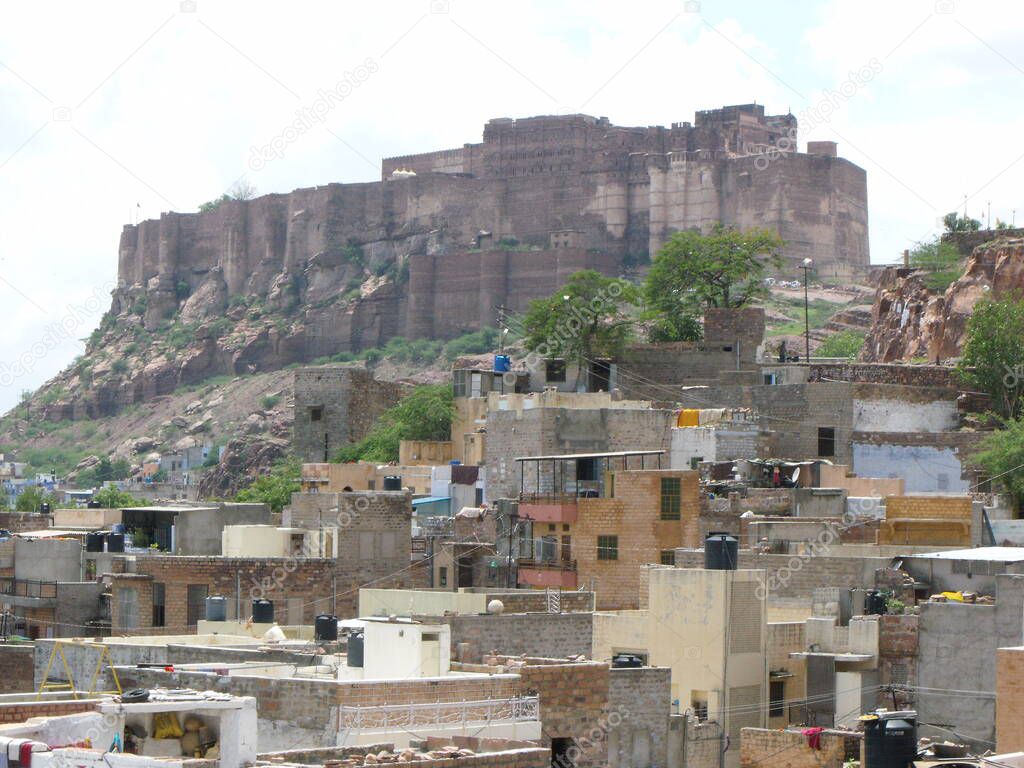 Jodhpur, Rajasthan, India, August 14, 2011: Mehrangarh Fort seen from a Jodhpur neighborhood