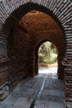 Malaga, Spain, May 8, 2022: Brick arches inside the Alcazaba of Malaga. Palatial fortification from the Islamic era built in the 11th century
