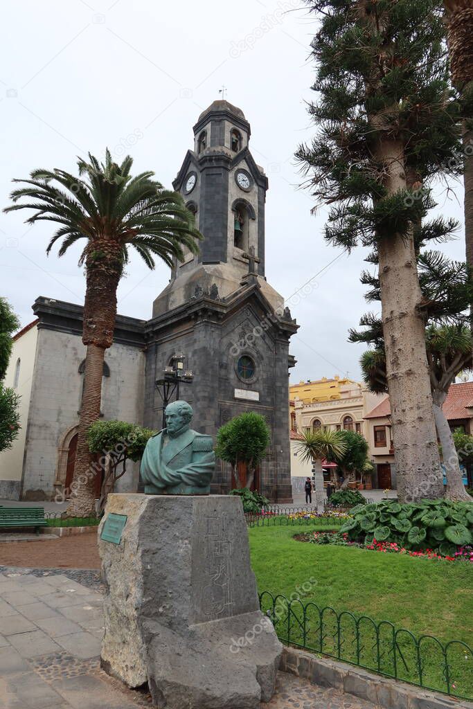 Puerto de la Cruz, Tenerife, Canary Islands, Spain, May 27, 2022: Monument to Agustin de Betancourt y Molina in front of the church of our lady of the rock of France in Puerto de la Cruz, Tenerife