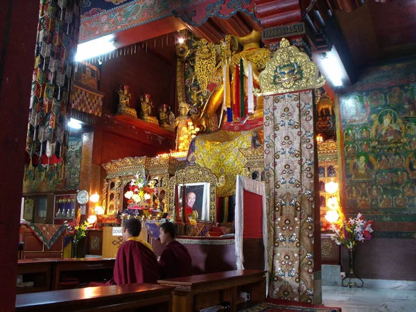 Kathmandu, Nepal, August 20, 2011: Two monks inside a temple at the Boudhanath Stupa in Kathmandu, Nepal
