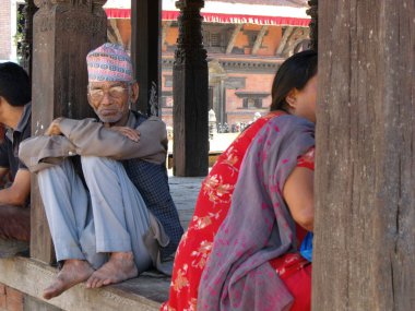 Durbar Square, Patan, Kathmandu, Nepal, August 20, 2011: An elderly man sitting in Durbar Square, Patan, Kathmandu, Nepal