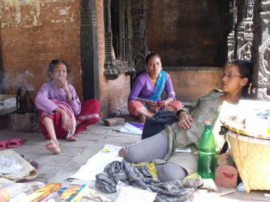 Durbar Square, Patan, Kathmandu, Nepal, August 20, 2011: Three women rest in the shade in Durbar Square, Patan, Kathmandu, Nepal