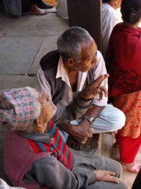 Durbar Square, Patan, Kathmandu, Nepal, August 20, 2011: Two men sitting in the shade in Durbar Square, Patan, Kathmandu, Nepal