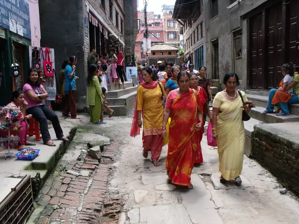 Durbar Square, Patan, Kathmandu, Nepal, August 20, 2011: Women walking on a street in Durbar Square, Patan, Kathmandu, Nepal