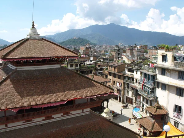 Kathmandu, Nepal, August 20, 2011: Rooftops and buildings with the mountains in the background in Kathmandu. Nepal
