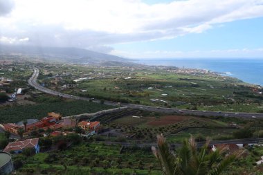 La Orotava, Tenerife, Spain, February 23, 2022: View of Puerto de la Cruz from the Humboldt viewpoint with the Atlantic in the background and the north highway TF-5 in the valley of La Orotava, Tenerife. Spain