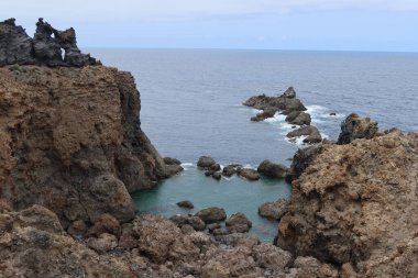 Icod de los Vinos, Tenerife, Canary Islands, Spain, August 30, 2022: Natural pool surrounded by volcanic rocks at Punta de Juan Centellas in Icod de los Vinos, Tenerife, Spain