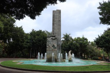 Parque Garcia Sanabria, Santa Cruz de Tenerife, Canary Islands, Spain, March 27, 2022: Fountain and monument in honor of Santiago Garcia Sanabria in Parque Garcia Sanabria in Santa Cruz de Tenerife, Spain clipart
