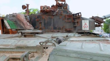 crow exploring and hiding something on the burnt tank