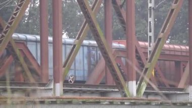 Railway train running at its own speed on its track over the river