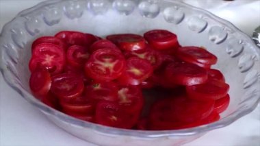 Cleanly cut red tomatoes are decorated to be eaten in the form of salad.