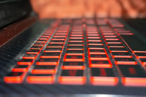 An attempt has been made to show the laptop keyboard from the side whose red light is burning