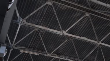 Büyük, modern bir odanın metal yapı tavanı. Büyük bir restoranın modern tavan yapılarından oluşan bir panorama. Modern depo inşaatı, yapısal çelik yapı ticareti