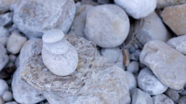 Çakıl taşları havuzunu dengelemek için arka planda odak noktasını kaybetme. Gölün kenarında dengelenmiş kayalar.
