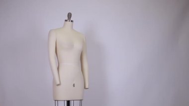 Kumaş ve metalik eski model elbise mankeni temiz ve temiz arka planda tek başına duruyor..