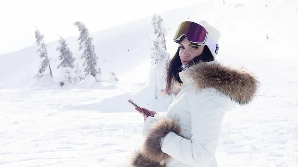 运动和人的概念 户外冬季肖像 在雪地的冬日公园里 一个漂亮的微笑的女孩正在用手机交谈 — 图库照片