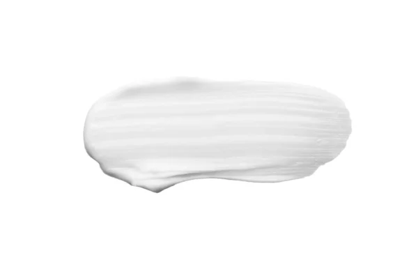 Pequeña mancha de crema hidratante blanca suave sobre blanco Imagen De Stock