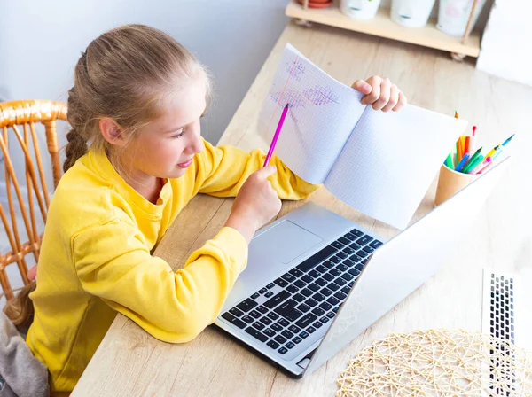 Chica haciendo la tarea de matemáticas en casa usando el ordenador portátil que muestra el ejemplo resuelto para el maestro — Foto de Stock