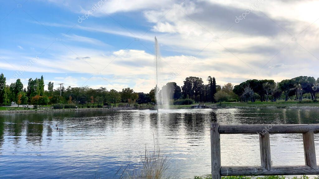 Parque de las Cruces, an urban park with lakes, a fountain, a children's play area and a field for dogs, in Madrid, Spain. Europe. Horizontal photography.