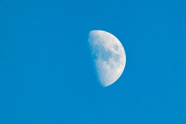 Bright crescent moon over the completely blue sky. Horizontal photography. Hunter\'s moon. Super full moon with dark background. Madrid, Spain, Europe. Horizontal Photography. 28. October. 2023. Moon. Supermoon. Sulfur. Conjunction. Venus. Saturn.