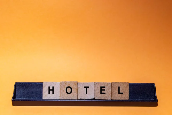 Hotel Word Written Square Wooden Tiles Orange Background Horizontal Photography — Stockfoto