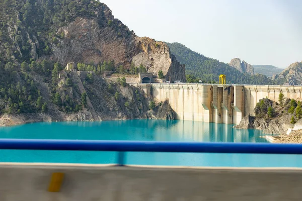 Swamp. Reservoir. Reservoir filled with blue colored water. Dam located on the border between the provinces of Castilla la Mancha and the Valencian Community, in Spain. Europe. Horizontal photography.