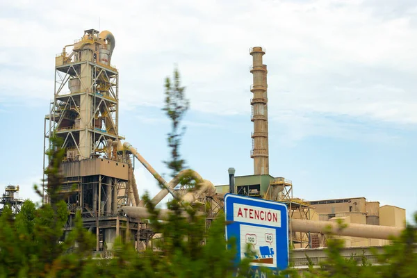 Factory. Cement factory seen from the outside on a cloudy day, in Spain. Europe. Horizontal photography.