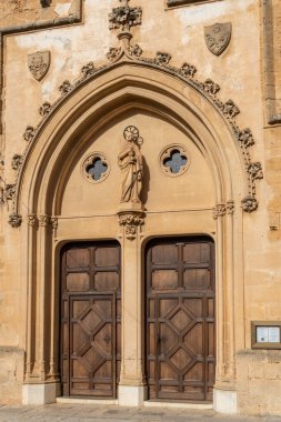 Main facade of the parish church of Sant Pere, located in the Majorcan town of Petra, on a sunny day