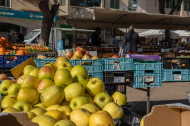 Campos, Spain; january 15 2022: Weekly street market in the Majorcan town of Campos. Vendors and customers with masks due to restrictions by the Omicron variant of Coronavirus. New normal