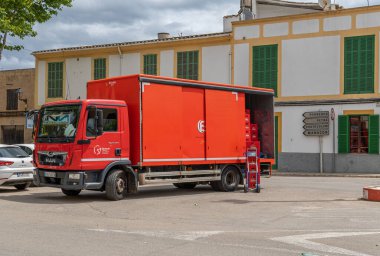 Felanitx, İspanya; 27 Mayıs 2022: İspanyol markası Estrella Damm 'ın kırmızı bira teslimat kamyonu, teslimatı yapmak için sokağa park edildi. Felanitx, Mayorka Adası, İspanya